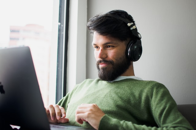 Man with laptop and headphones
